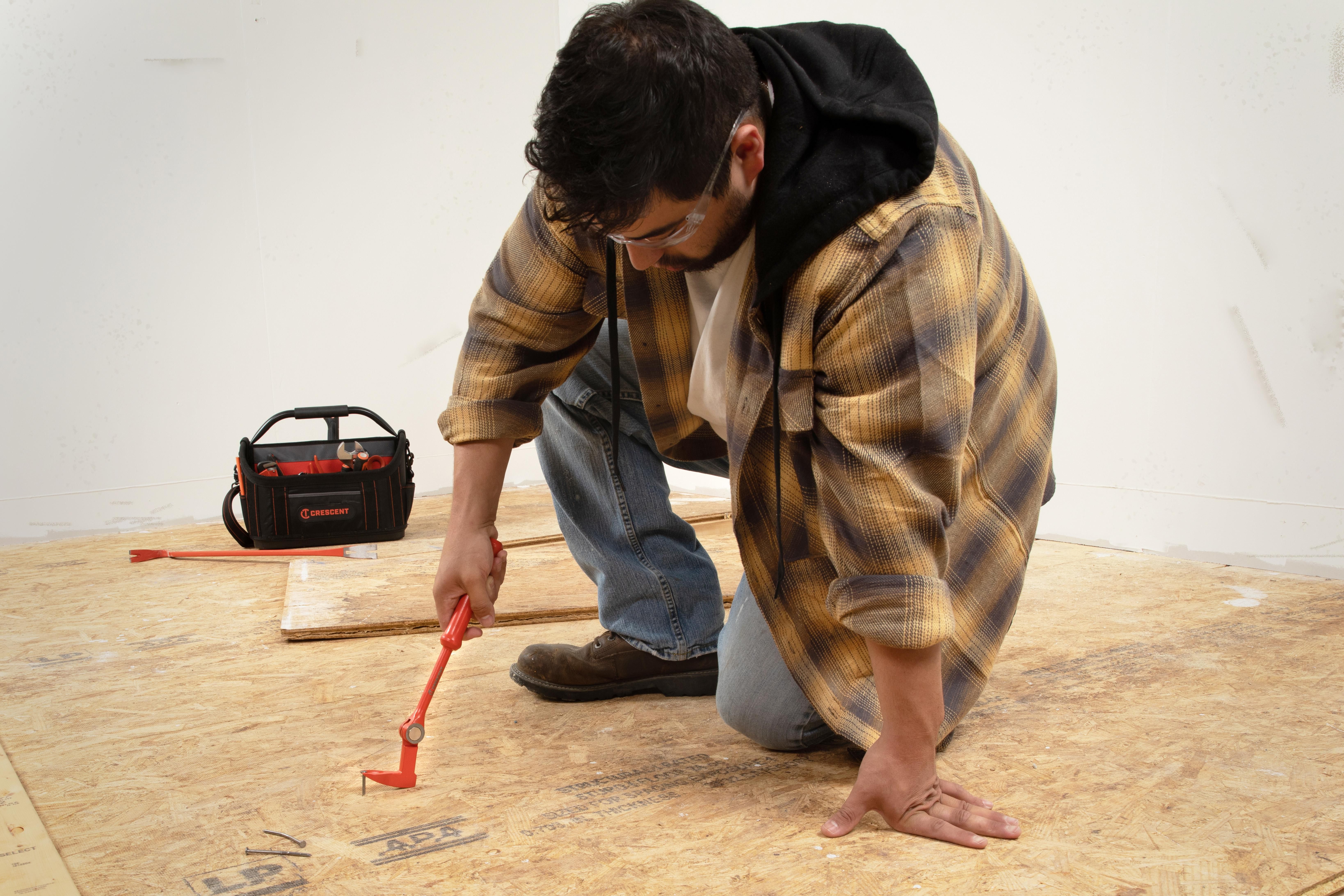 Crescent 12-in. Indexing Nail Puller pulling a nail from a wood board
