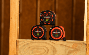 Crescent Tools NITE EYE 25 foot tape measures (SHOCKFORCE, WORKHORSE, and CONTROLTOUCH) sitting between studs on a new house build