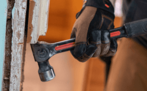 Crescent ripping hammer being used to pry lumber apart