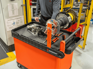 Man using a Crescent RAILWORKS cart with wire spool holder to make repairs