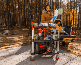 Man loading up a Crescent SITERUNNER jobsite cart from his pickup truck