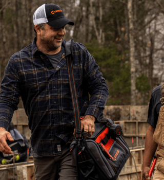 Two men walking on a new home construction site