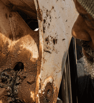 Male construction worker using a Crescent quick fit adjustable wrench to tighten a bolt on a construction vehicle