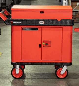 Three RAILWORKS Utility Carts kitted with various RAILWORKS Cart accessories lined up facing forward in a distribution and manufacturing plant setting