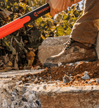 Man using a Crescent HEADLOCK sledgehammer to break concrete