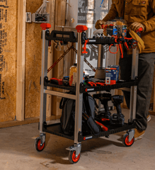 Male contractor using a loaded down SITERUNNER cart in a new home build