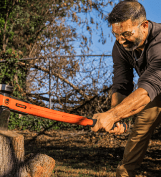 Man using a Crescent HEADLOCK axe to split wood