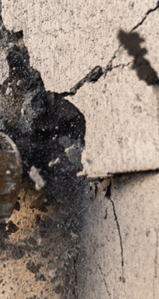 Crescent HEADLOCK sledgehammer hitting a cinder block wall to break the blocks apart