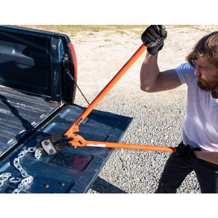Industrial Grade Center Cut Cutter being used to cut chain on the tailgate of a pickup truck.