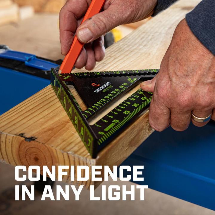 CRS07 7-inch NITE EYE™ rafter square being used to mark a wood board, demonstrating confidence and visibility in varied lighting.
