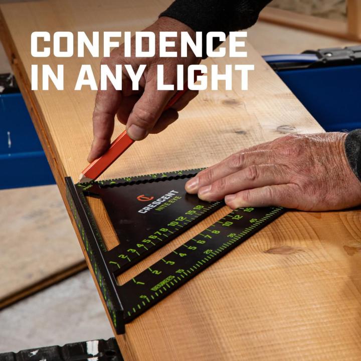 CRS12 12-inch NITE EYE™ rafter square being used to mark a wood board, demonstrating confidence and visibility in varied lighting.