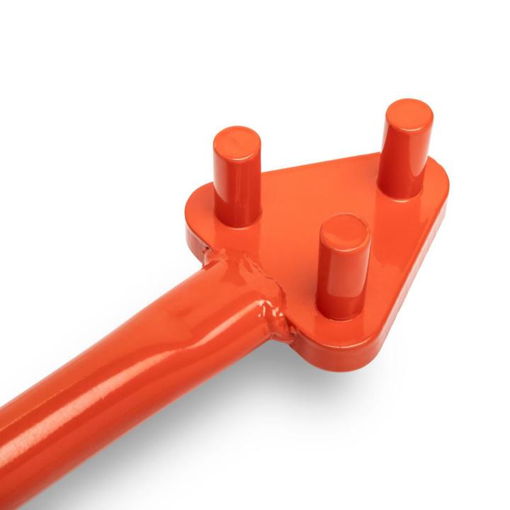 Close-up of the orange Crescent rebar bender's triangular head with three upright cylindrical pins; the handle extends toward the lower left on white.