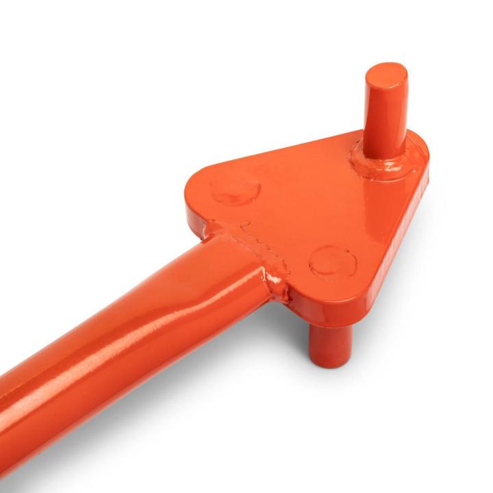 Close-up of the orange Crescent rebar bender head showing one upright pin and two pin ends below the plate; the handle extends toward the lower left on white.