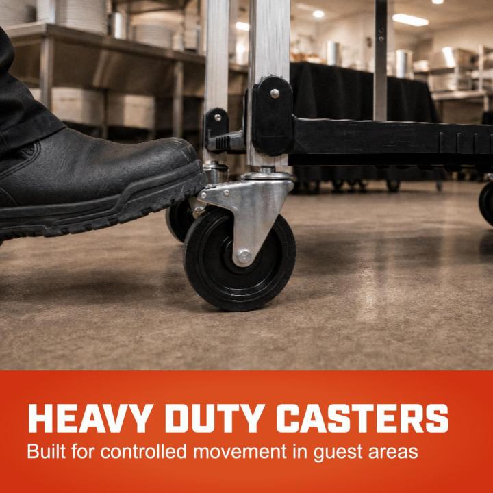 Black boot presses a cart caster on a commercial kitchen floor. Text readsheavy duty casters built for controlled movement in guest areas.