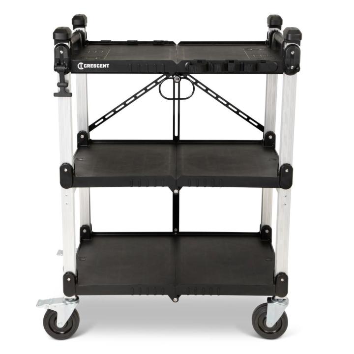 Front view of a black-and-white Crescent SITERUNNER collapsible utility cart with three shelves, four casters, raised corner handles, and diagonal rear braces. Crescent logo on top shelf; white background.