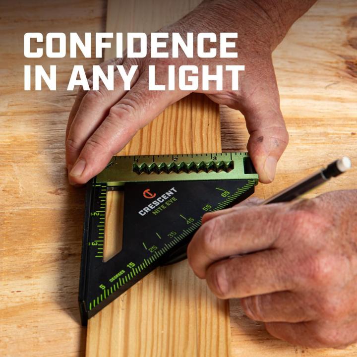 LSSP4NE 4-inch NITE EYE™ layout square being used to mark wood, demonstrating confidence and visibility in varied lighting.