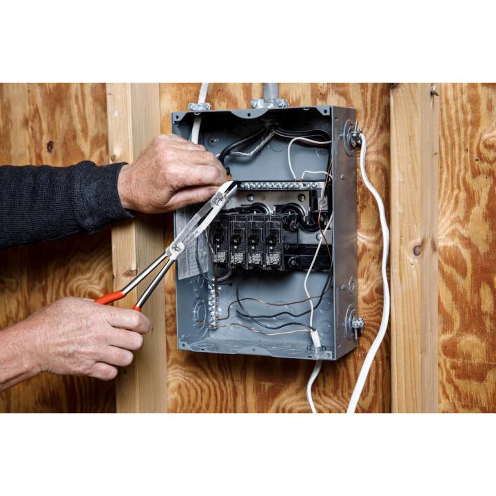 A person using the PSX202C-06 on a circuit breaker box