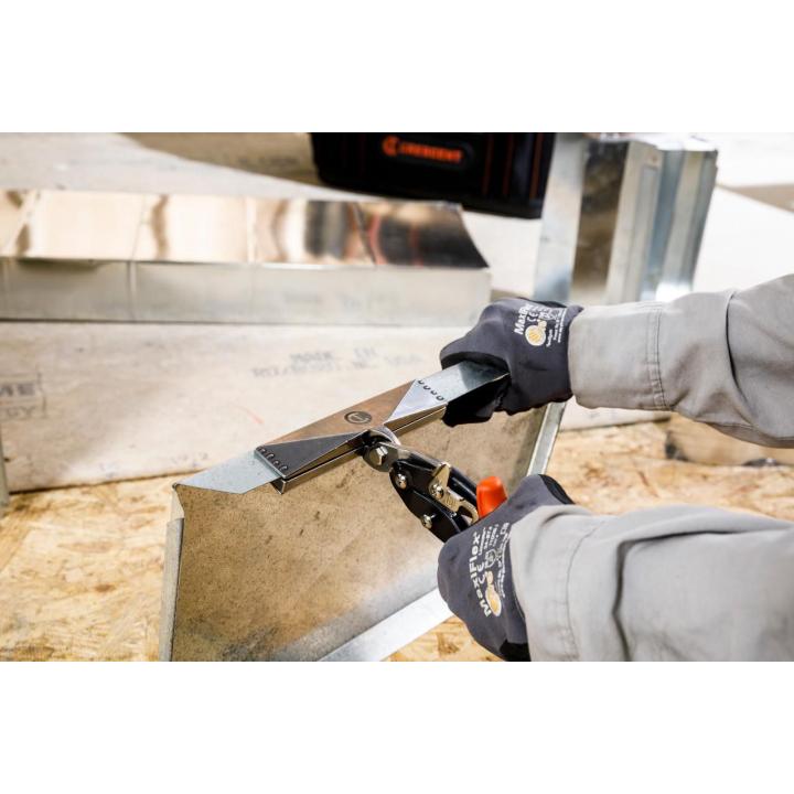 Gloved worker uses a Crescent WS6N hand seamer to bend sheet metal near ductwork in a workshop setting.
