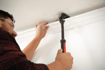Man using a Crescent DB18X-06 indexing pry bar to remove molding