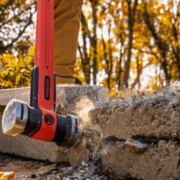 Man using a Crescent HEADLOCK sledge hammer to break up rock