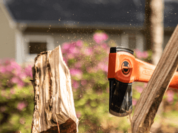 Man using a Crescent hatchet to split wood
