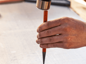 Man using a Crescent pin punch to mark sheet metal