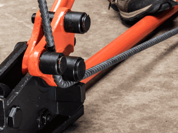 Person using a Crescent rebar bender to bend rebar